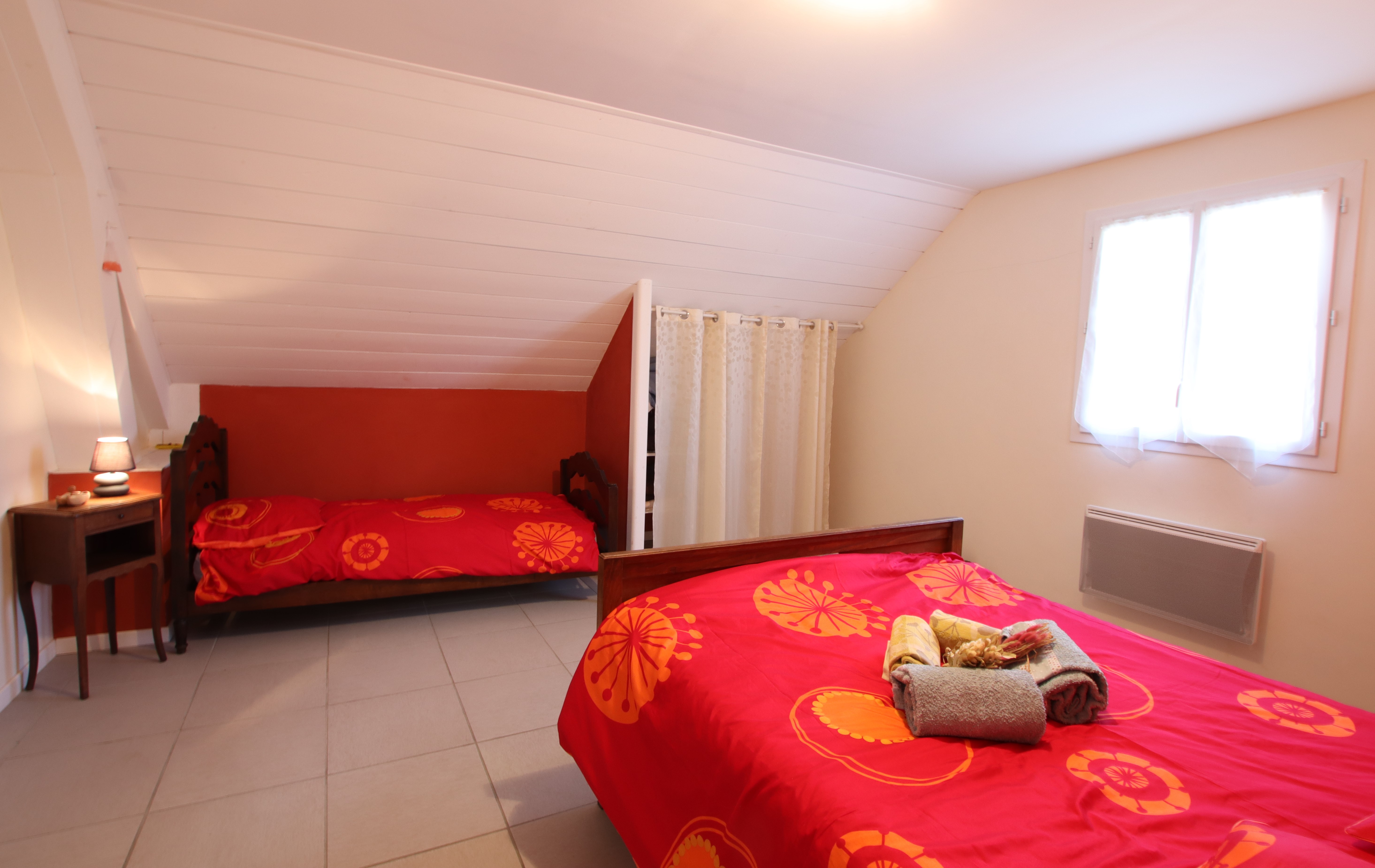 chambre rouge avec 1 lit double et 1 lit simple 
